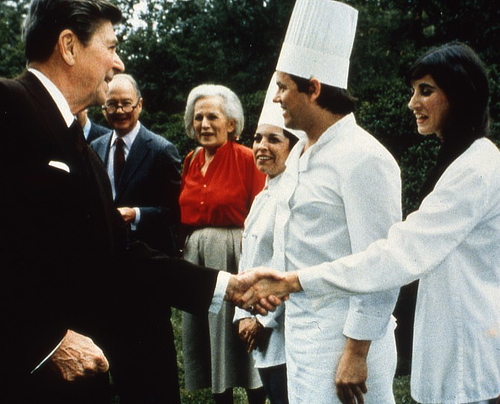 Barbara Lazaroff and Wolfgang Puck shake hands with President Ronald Regan during the president's 1983 Economic Summit.